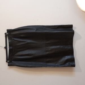 Woman's black leather skirt.